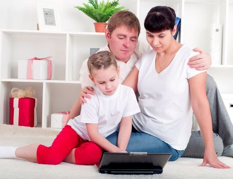 family are working together for a laptop at home