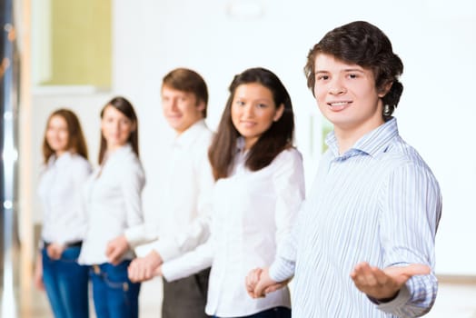 group of people holding hands, man holds out his hand, the concept of teamwork