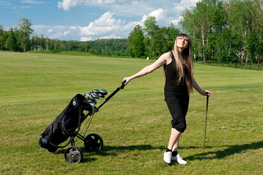 Beautiful women stay on green golf field