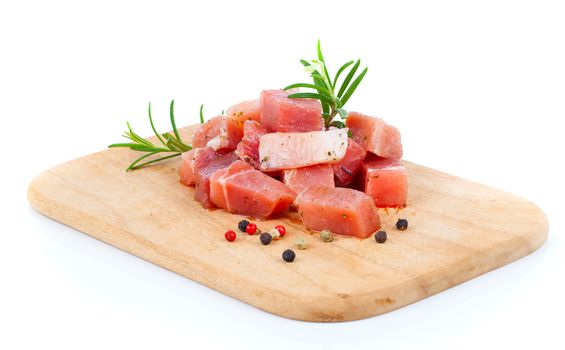 pieces of raw meat on a kitchen board, on a white background