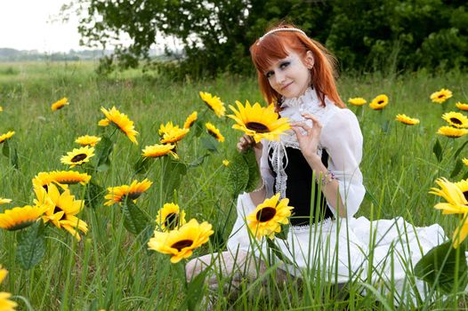 red-haired nymph in a white dress on a fairy glade