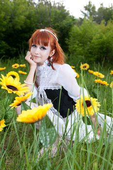 red-haired nymph in a white dress on a fairy glade