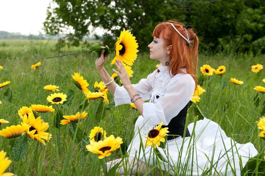 red-haired nymph in a white dress on a fairy glade