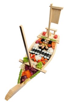 Set of sushi on wooden stand in the form of the boat isolated on white