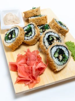 rolled sushi on  wooden stand isolated on white background