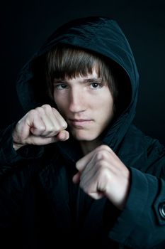 young man in the jacket on a black background