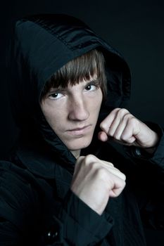 young man in the jacket on a black background