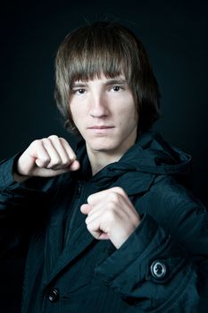 young man in the jacket on a black background