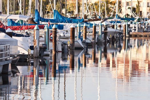 Boats and reflections of yachts in still water