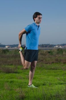 Male runner exercising outdoors on country landscape.