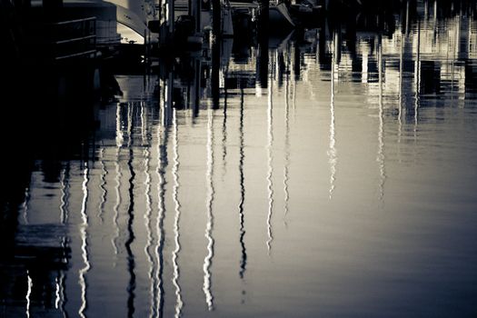 Boats and reflections of yachts in still water