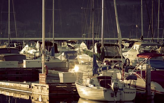 Boats and reflections of yachts in still water