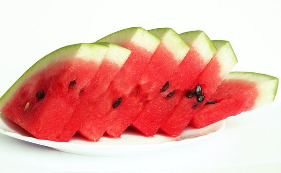 Slices of juicy watermelon served on white plate isolated on white background