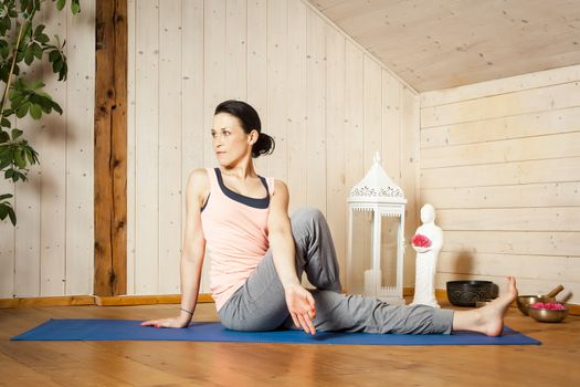 An image of a pretty woman doing yoga at home -