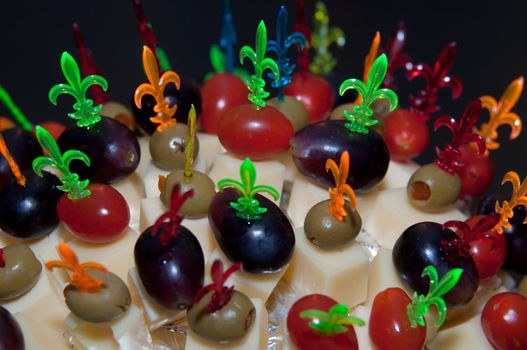 hedgehog made from sticks with delicious food - cheese, olives, tomatoes, grapes
