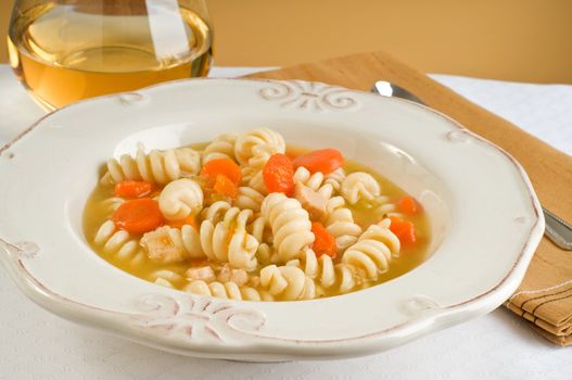 Elegant bowl of homemade chicken and pasta soup.