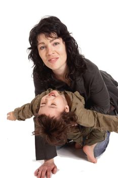 Young dark haired woman plays with her little son