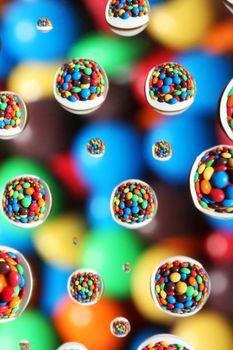 abstract background,colorful candies reflected in water drops