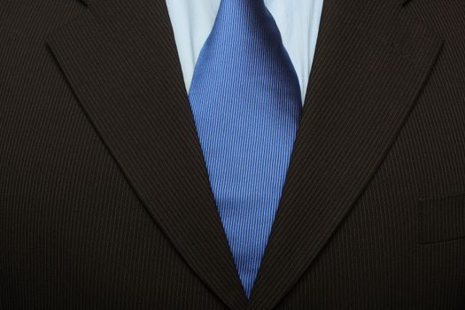cropped shot of torso part of a man in black suit