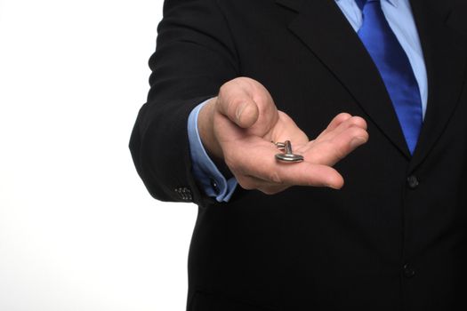 cropped shot of torso part of a man in black suit holding out house keys