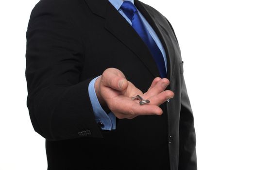 cropped shot of torso part of a man in black suit holding out house keys
