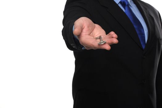 cropped shot of torso part of a man in black suit holding out house keys