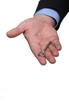 cropped shot of human hand in black suit holding out house keys