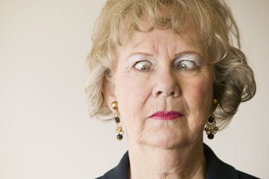 Close-up of a senior woman crossing her eyes.