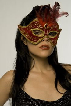 Attractive woman posing in red carnival mask