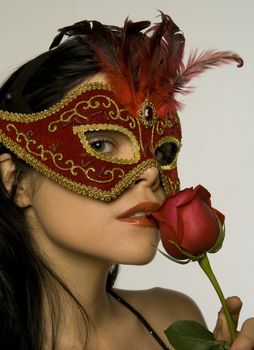 Attractive woman posing in red carnival mask