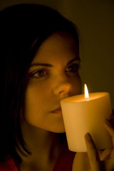Beautiful woman bathed in soft candle light