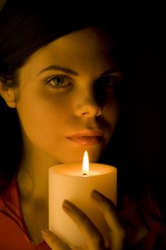 Beautiful woman bathed in soft candle light