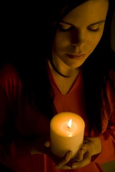 Beautiful woman bathed in soft candle light