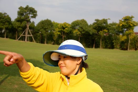 Golf caddie of China point to where the golf ball went