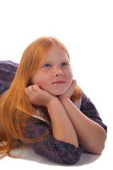 Dreaming redhead girl lying on the floor