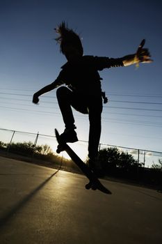 Teenage boy skateboarder with his board.