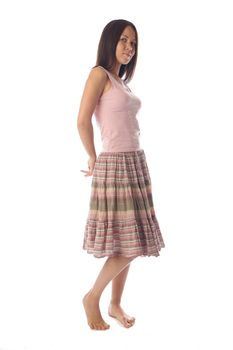 Dark haired young woman in skirt and tank top coquets