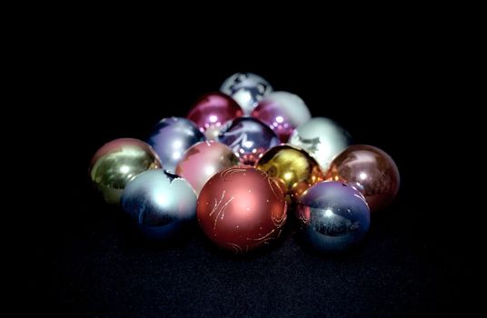 Multicolored Christmas glass spheres on black background