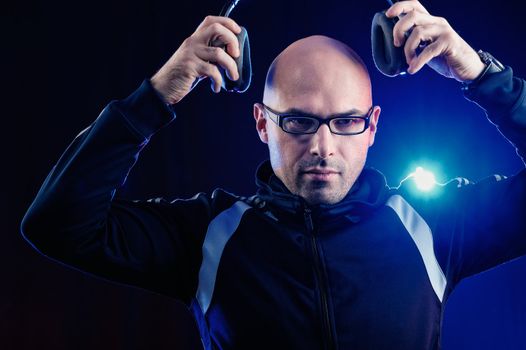 Man in glasses wearing headphones in the studio