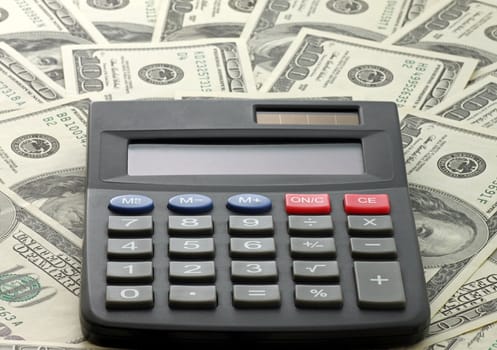 calculator on one hundred dollars banknotes