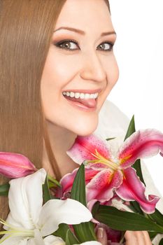 Portrait of young overweight woman holding lilies, smiling with tongue out at camera