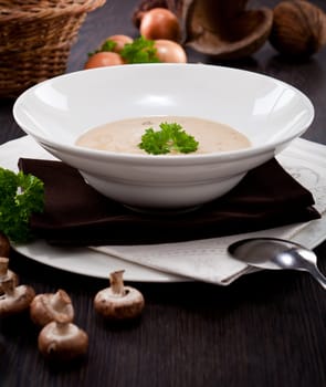 fresh chmapignon cream soup with parsley decorated on wooden table