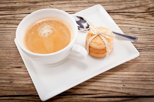 fresh aromatic coffee and cookies on wooden table 
