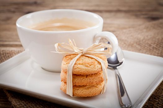 fresh aromatic coffee and cookies on wooden table 