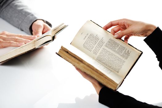 Man and woman reading an old book