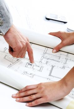 Architect�s hands pointing on the blueprint of new house project 