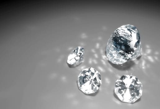 a closeup of a group of three small diamonds and a bigger one are lying down on a grey surface with some reflections of light around them