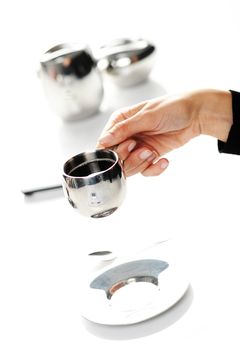 Hands of a woman holding a cup of coffee