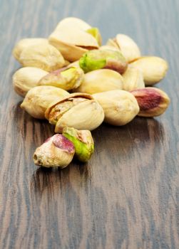 Heap of Perfect Pistachio closeup on Dark Wood background