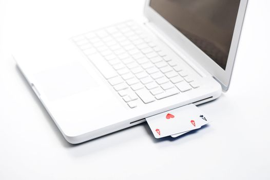 gambling online, aces on white laptop - concept photo